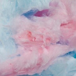 Close-up image of pink and blue cotton candy, showcasing the fluffy, sugary texture in blended pastel colors that look as tempting as a Quattro Kush Multipack (R).