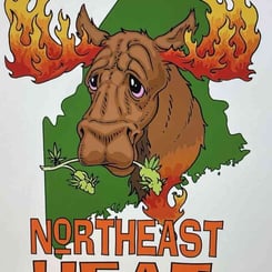 Certainly! It looks like the sentence already includes the product name "Northeast Heat (R)." Here it is again for clarity:

Illustration of a moose with flames on its antlers, holding cannabis leaves in its mouth, over a green map of the northeastern United States. Text below reads “Northeast Heat (R)”.