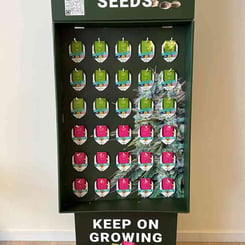 A Royal Queen Seeds Display features multiple packs of cannabis seeds. The bottom section reads "Keep on Growing," while a QR code at the top offers additional information.